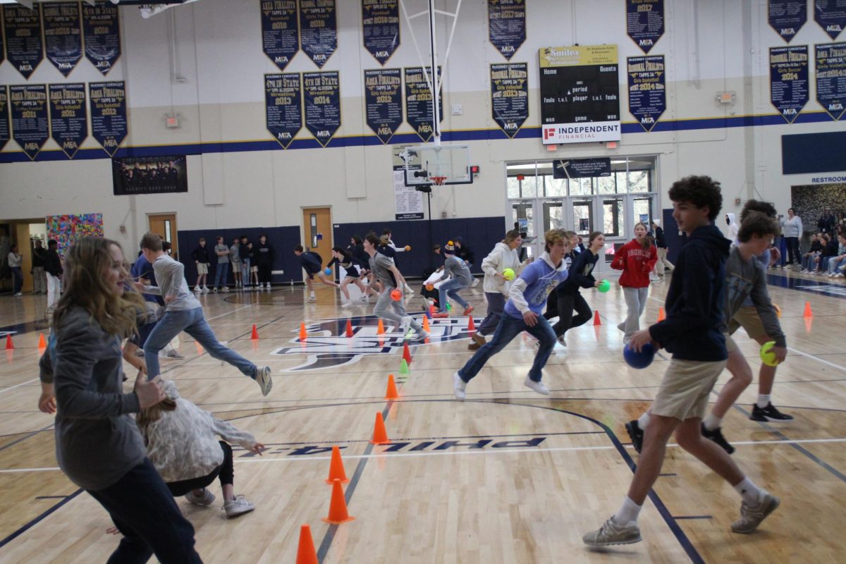 Freshman boys and girls run up to get balls