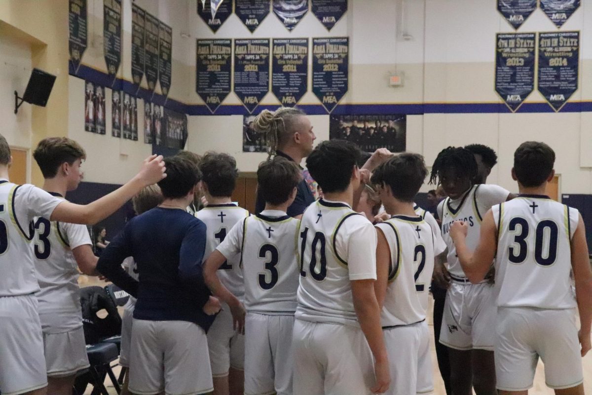 The coach talks to the team before the game. 