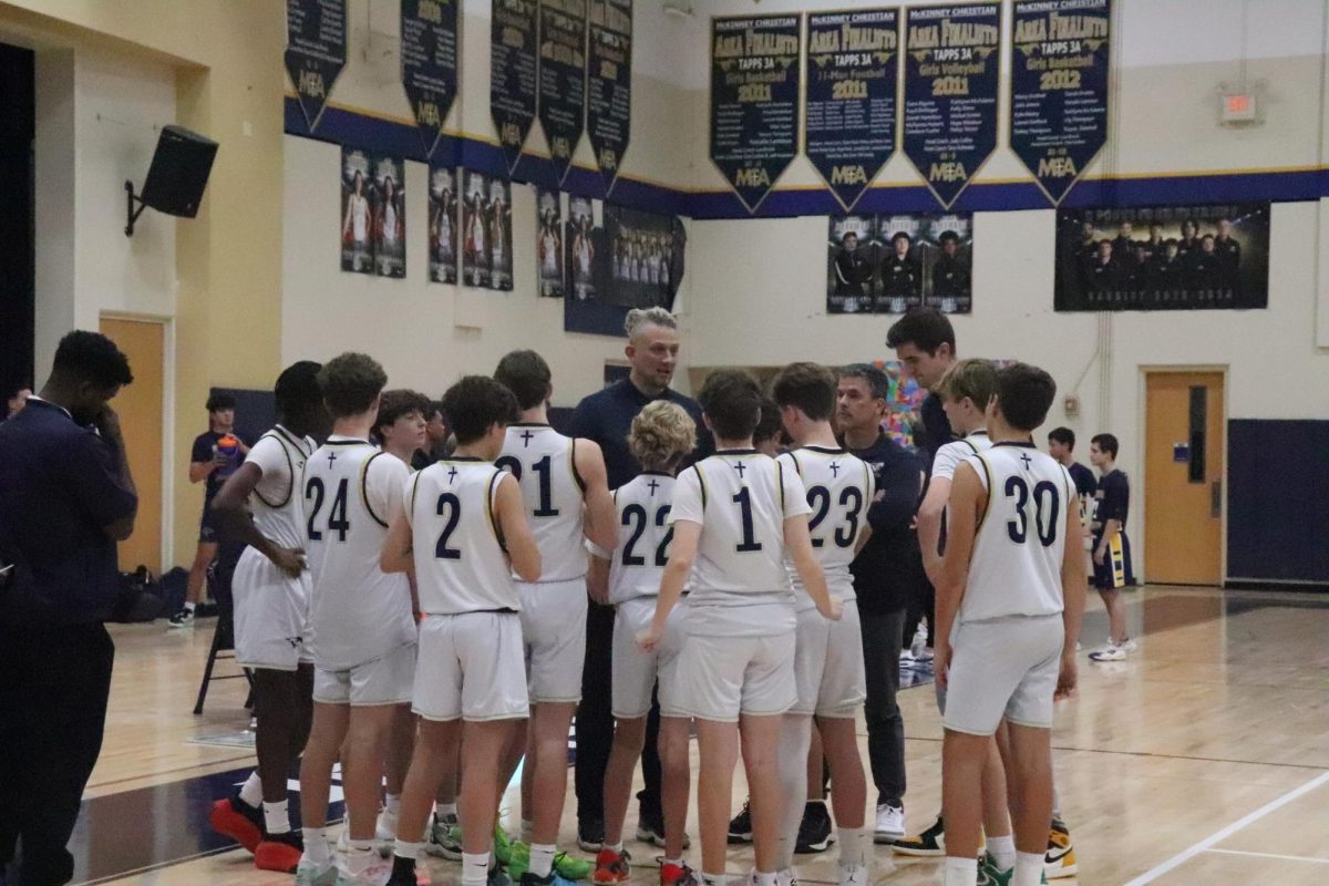 Boys basketball D1 team breaks out of huddle.