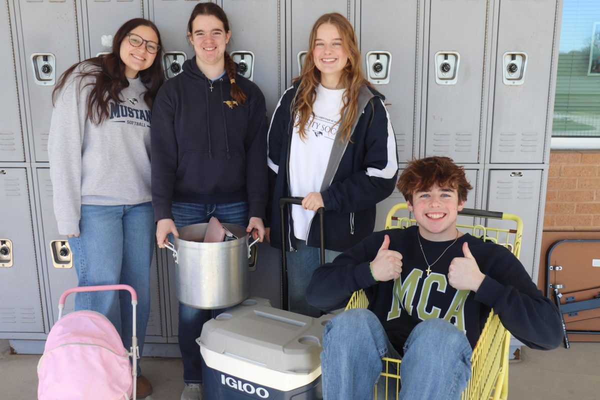 Junior girls and boys pose with  their backpacks.