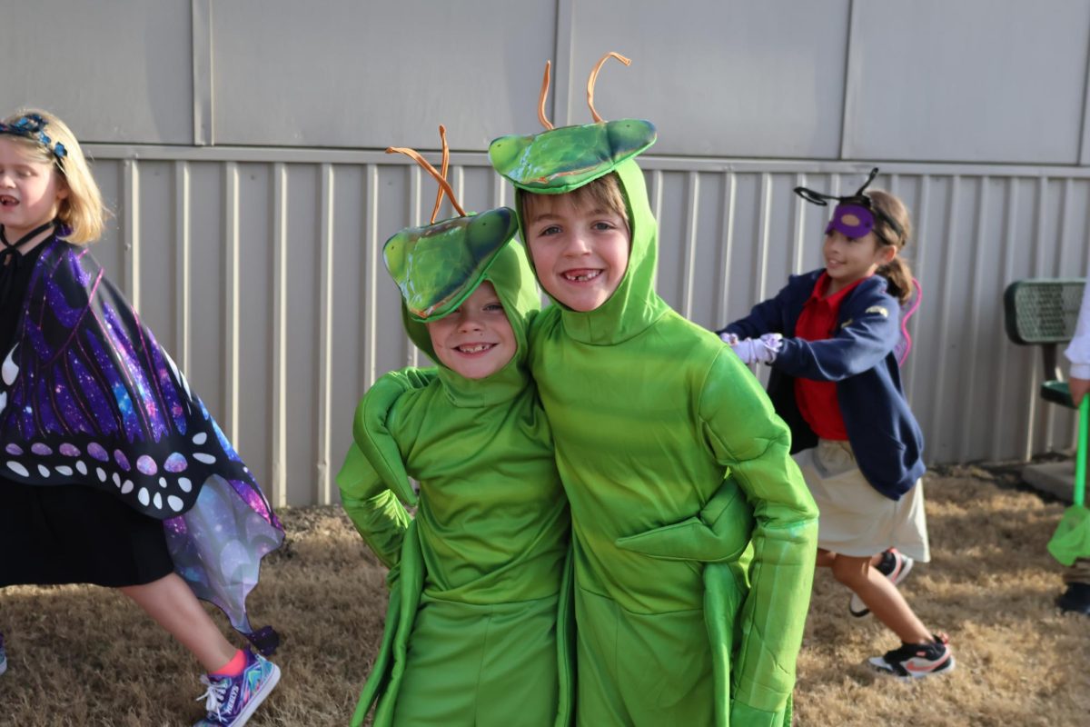 First grade friends hug together for a photo. 