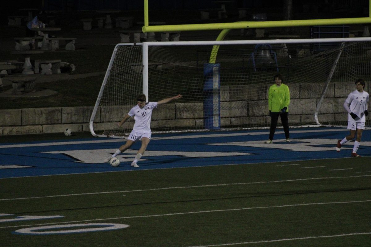 Junior Hudson Clayton kicks the ball.





