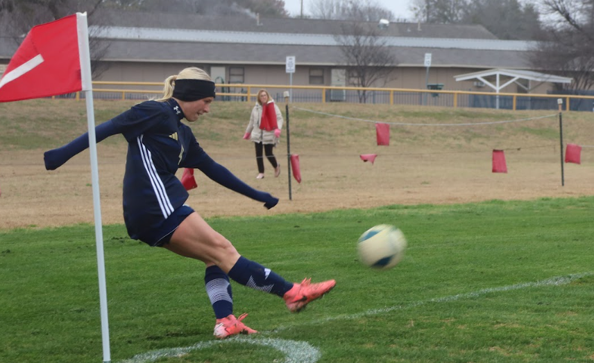 Junior Tatum Barnard kicks the ball into the field.