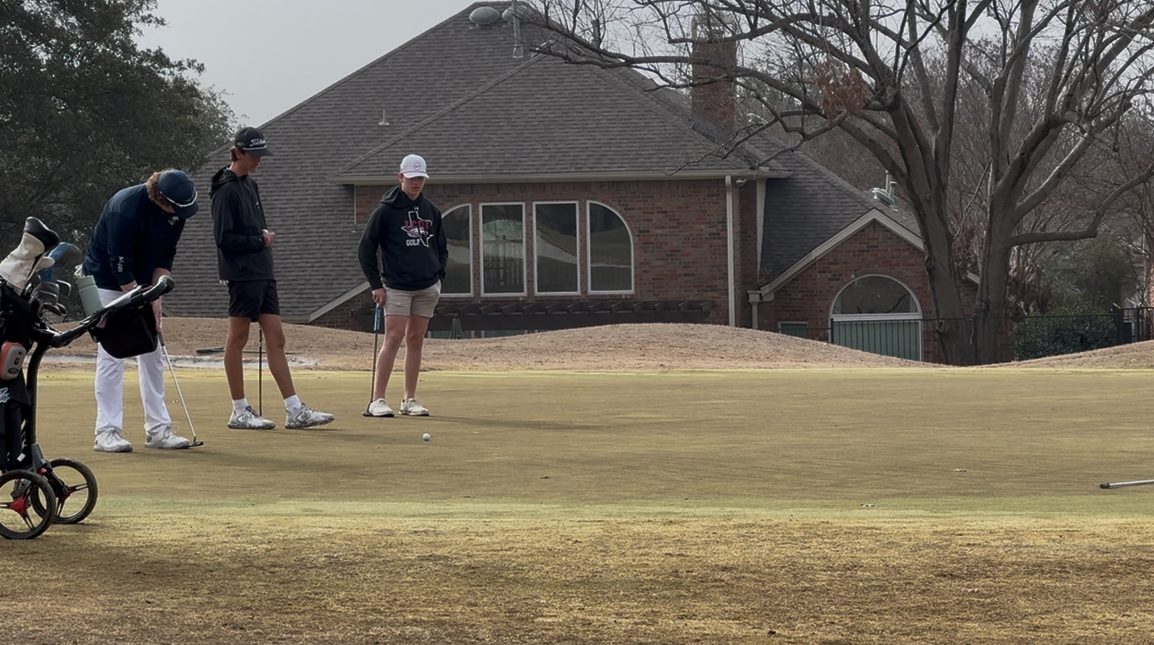 Players watch Luke Ryan putt.