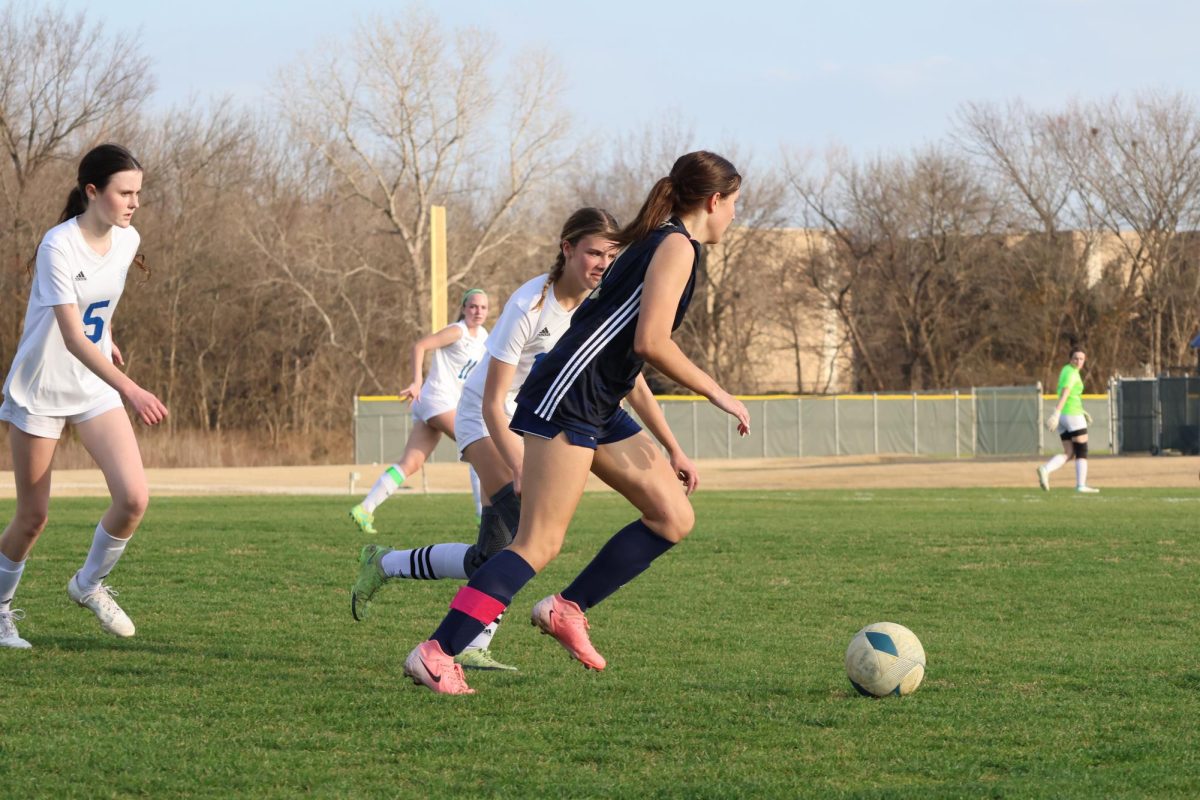 Senior, Casey Gerardis passes the ball to her teamates