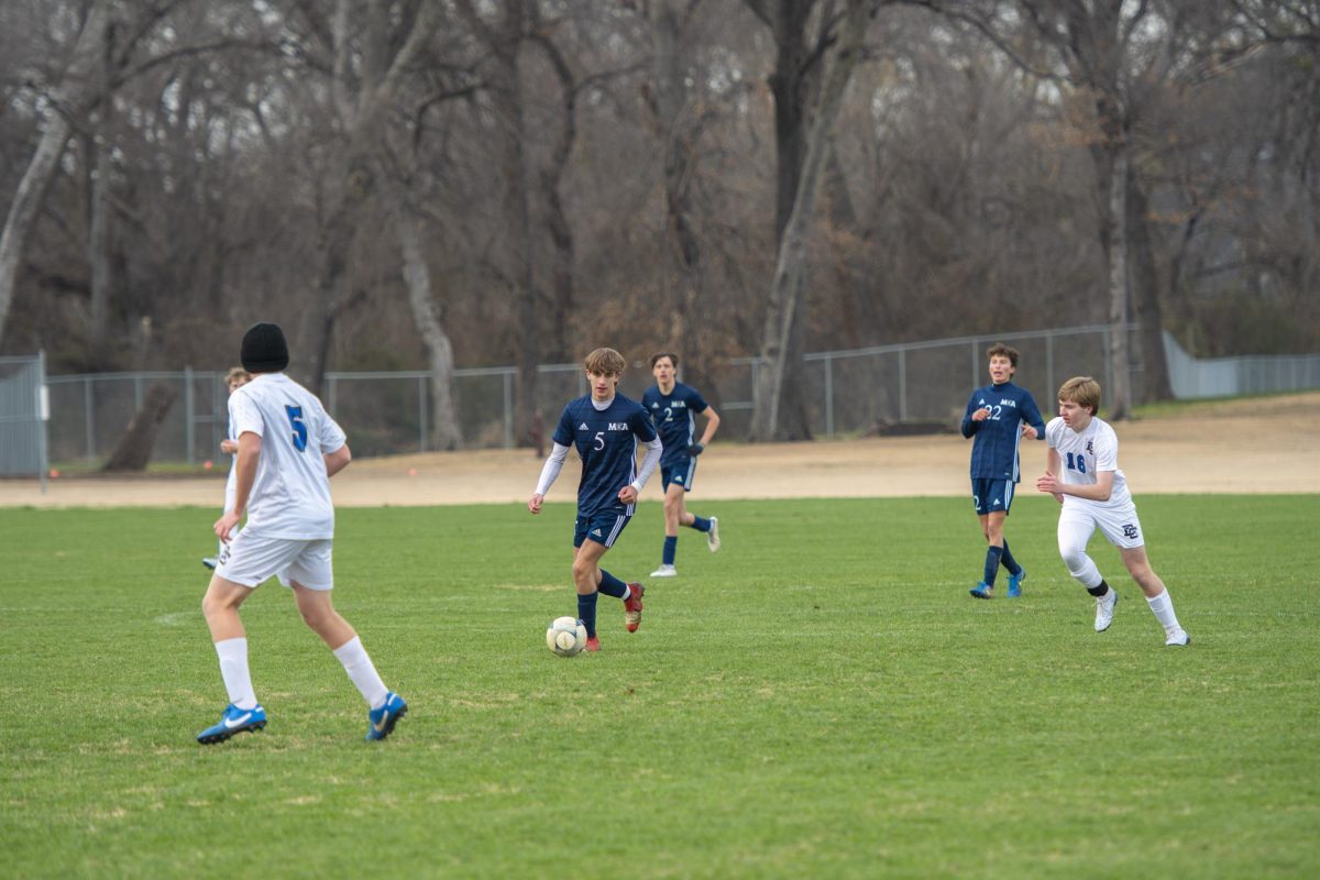 Tripp Barbour dribbling the ball down the field.