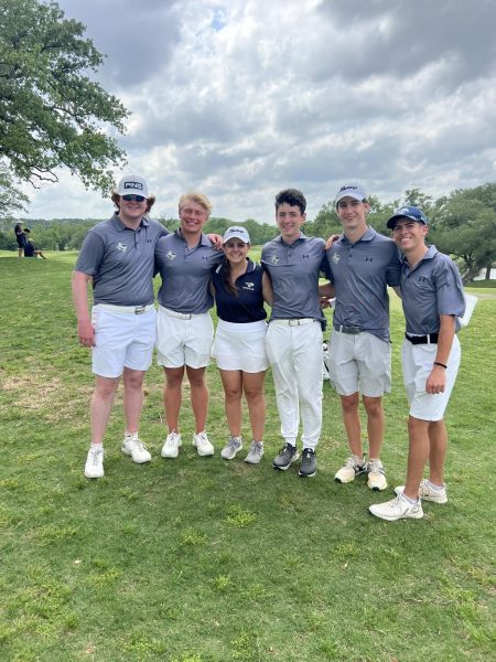 The boys golf team poses for a picture before they compete. 