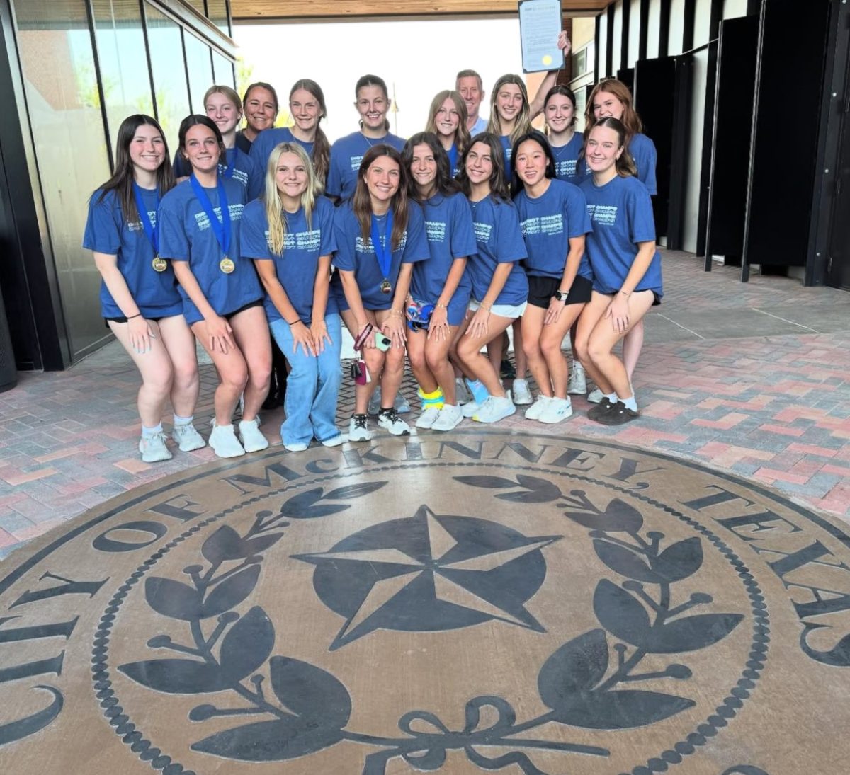 The team smiles for a photo outside the Meeting Room.
