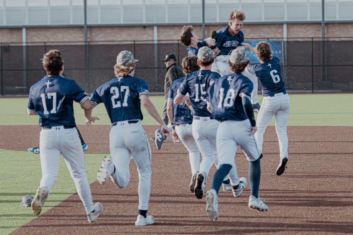 The team runs out to celebrate with the team.