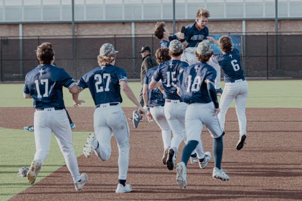 The team runs out to celebrate with the team.