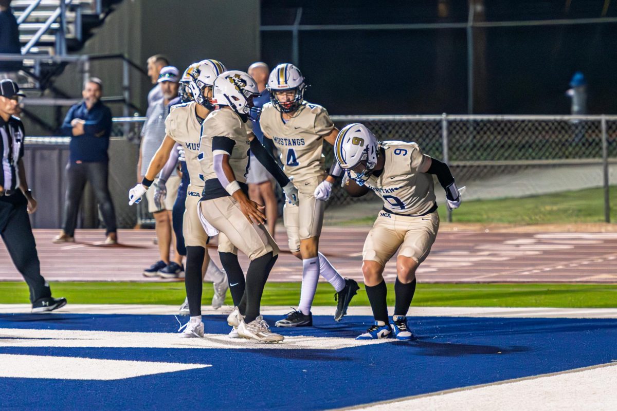 The Mustangs celebrate in the endzone after a touchdown senior Cody Dow. 
