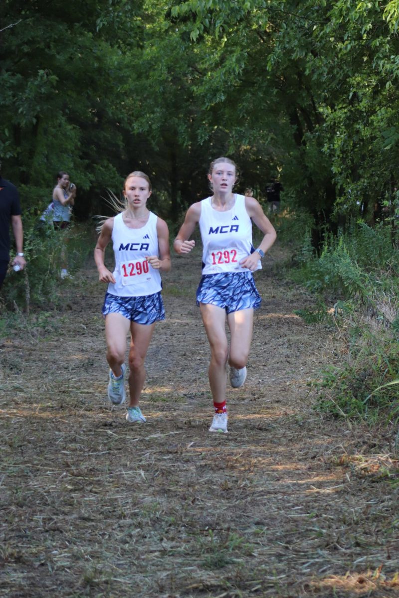 Senior Dylan Neuner and sophomore Carys Mejan run side by side.