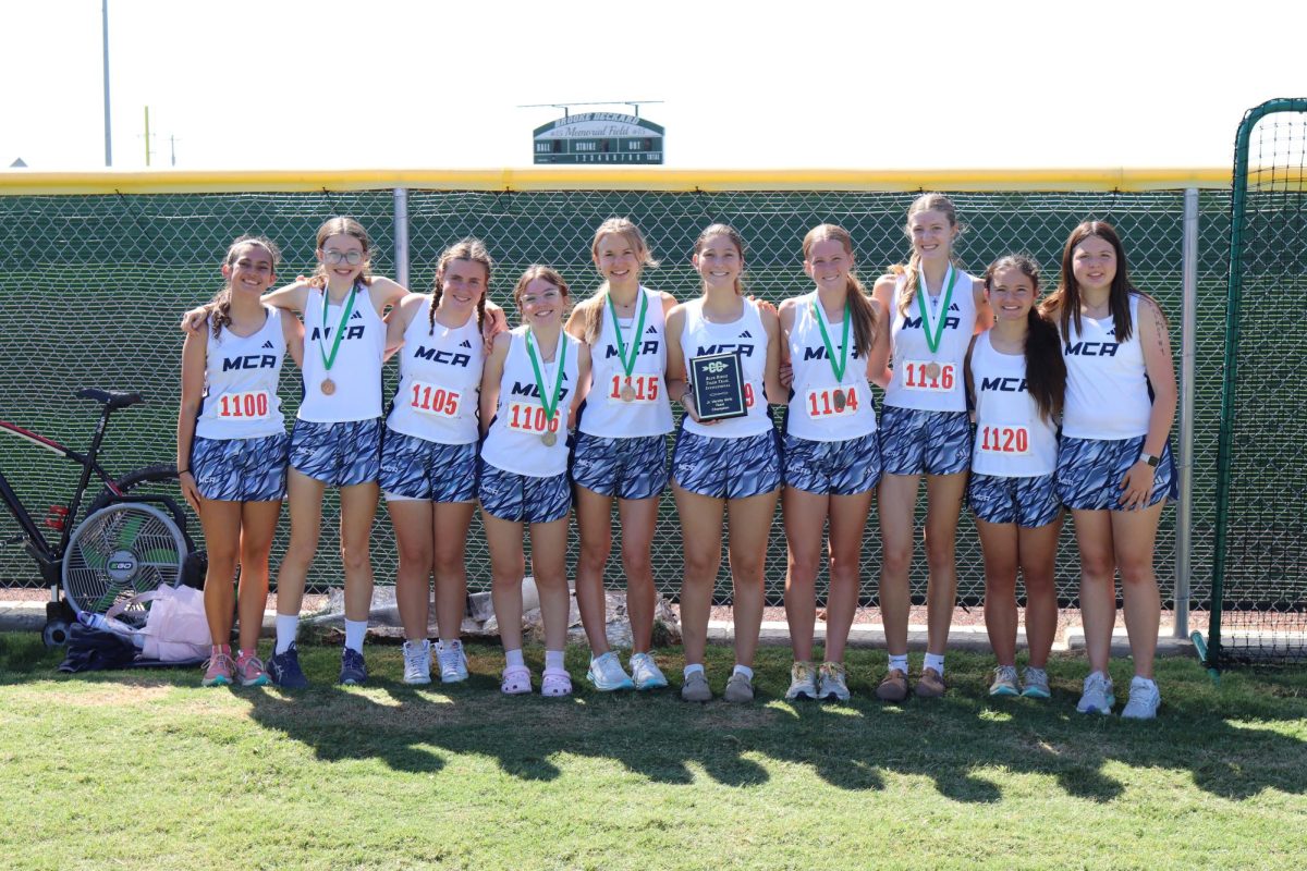 The Lady Mustangs pose for a picture with their medals and plaque. 