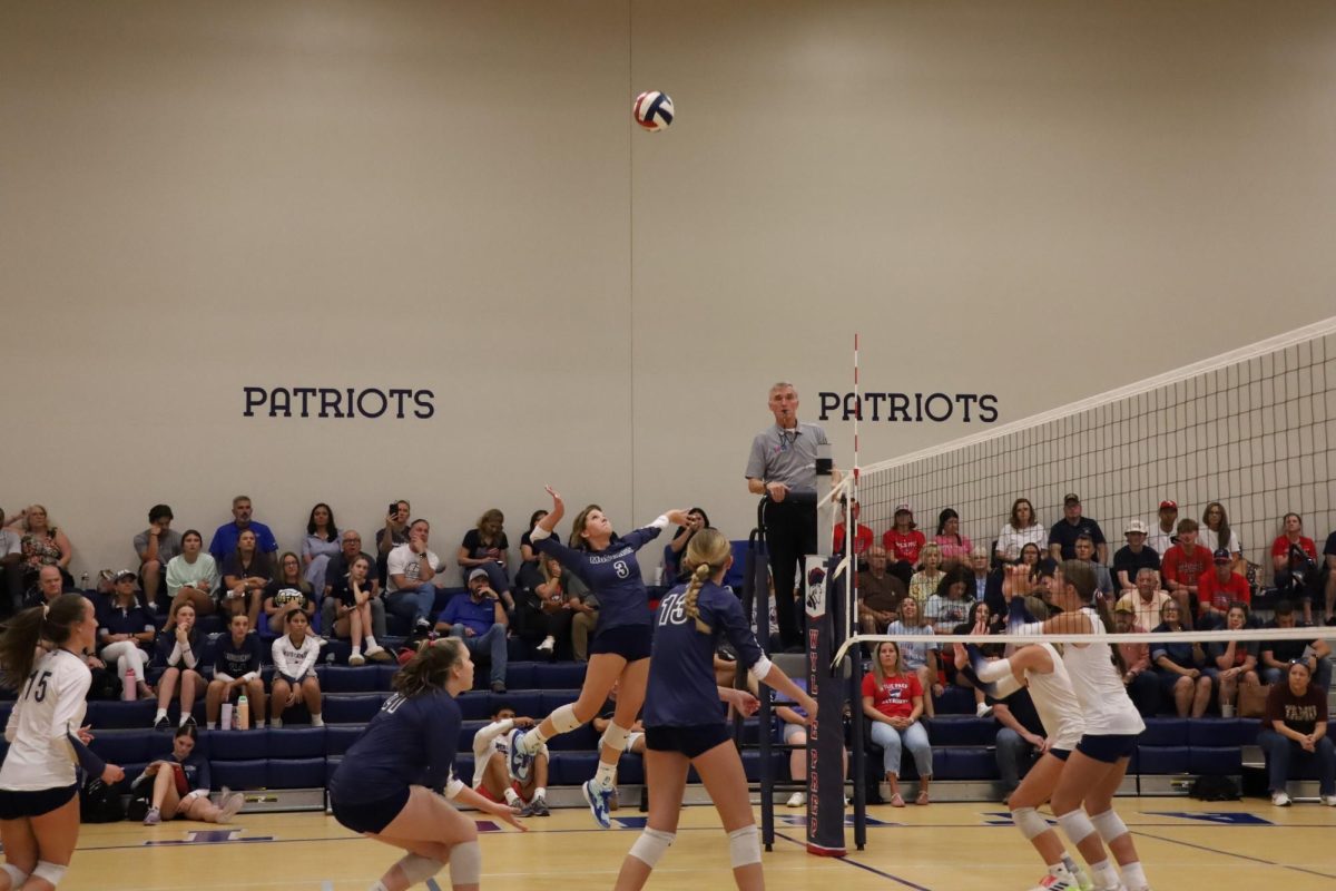 Sophomore Brittany Bartoo jumps high to hit the ball.