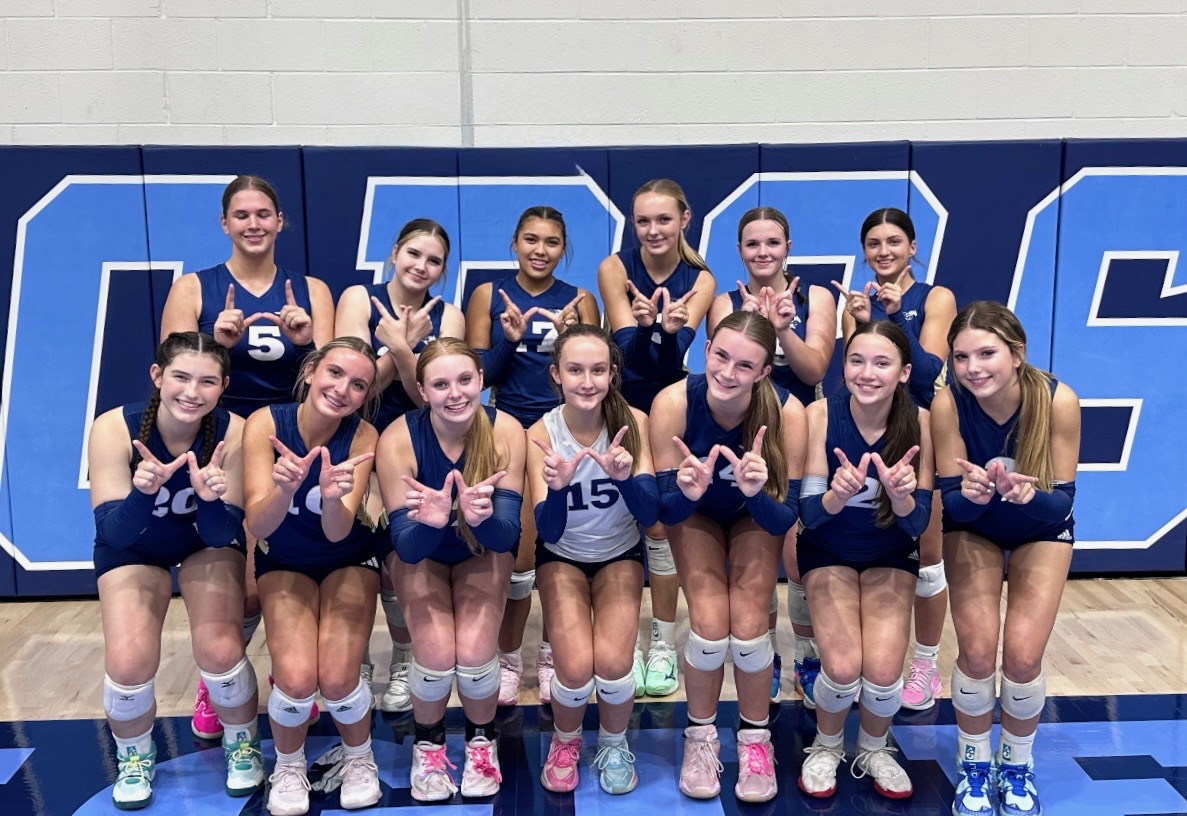 Varsity Mustangs pose, celebrating the win.