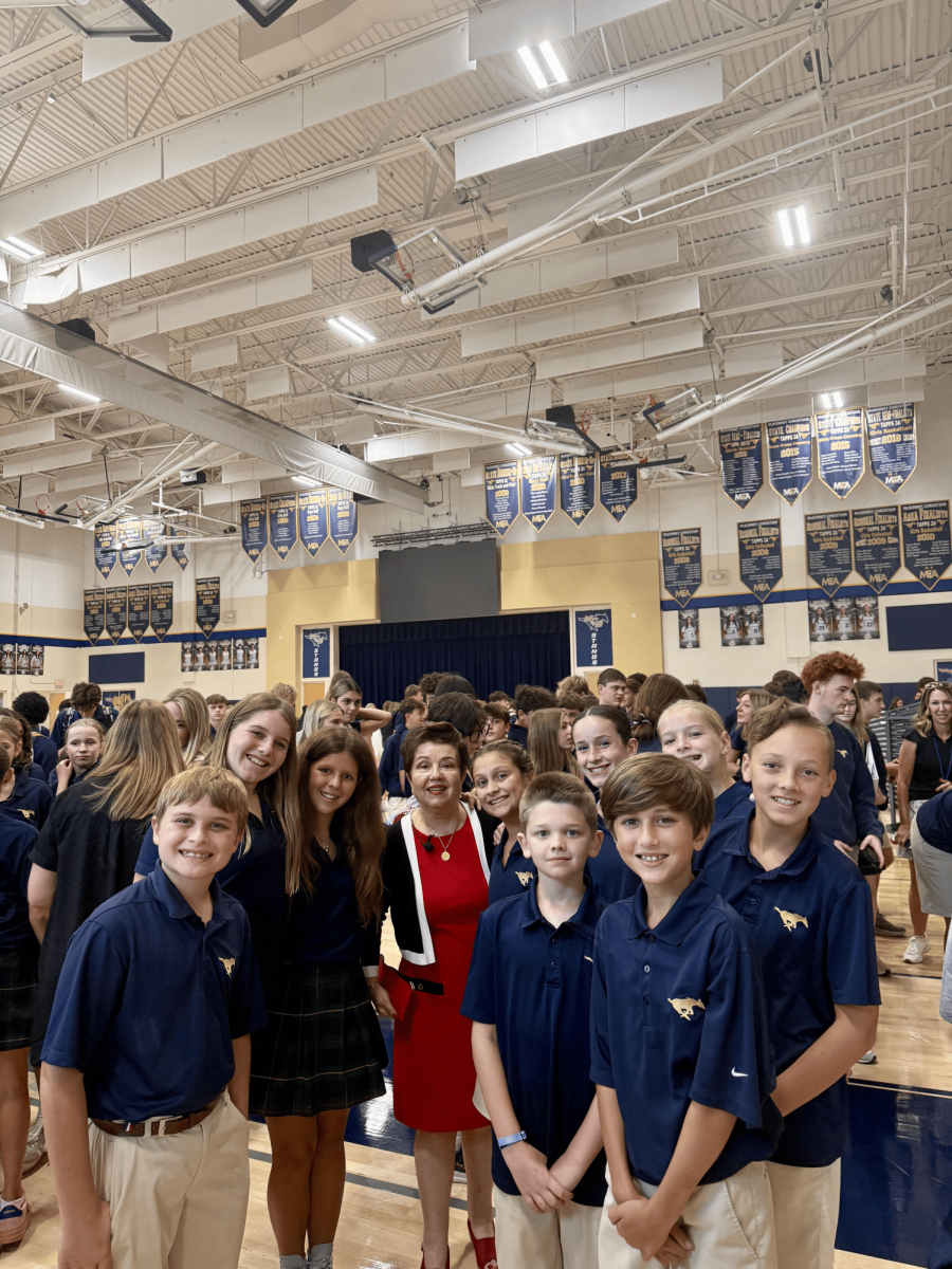 Students take picture with Virginia Prodan 