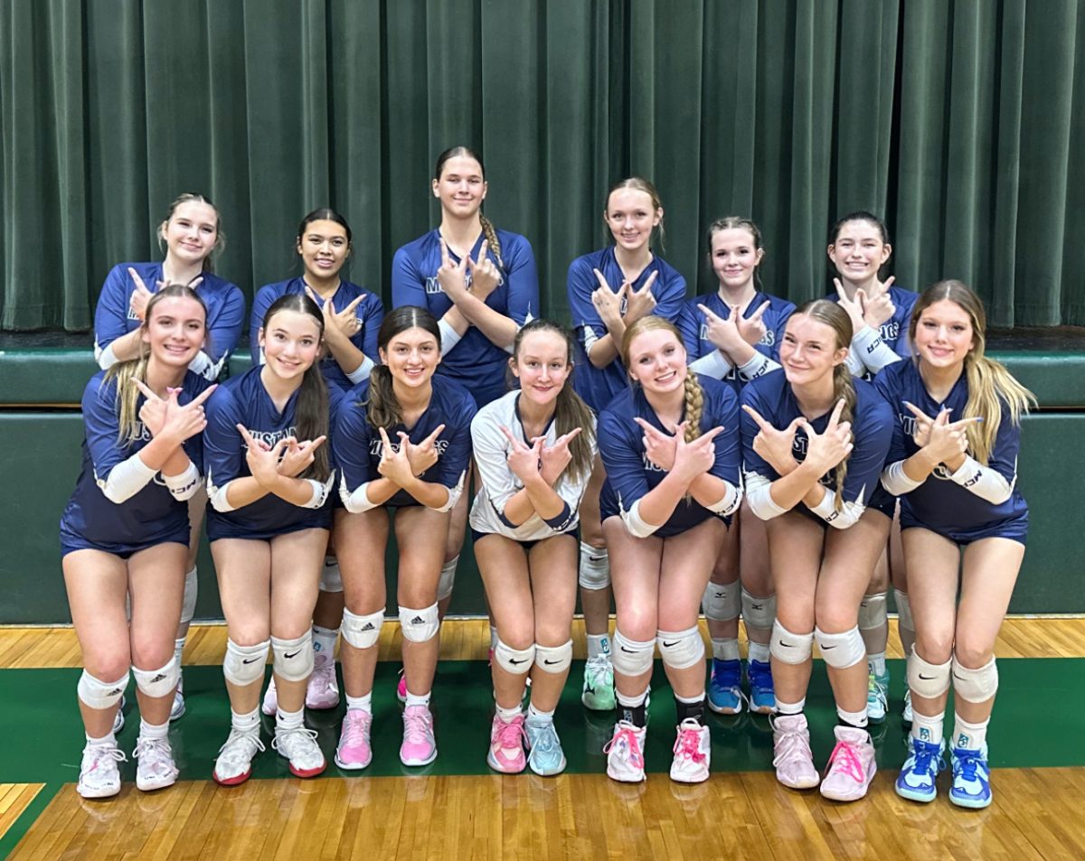 Team poses together after massive win.