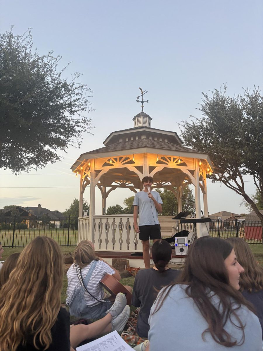 Senior Ben Thomas sings at worship night 