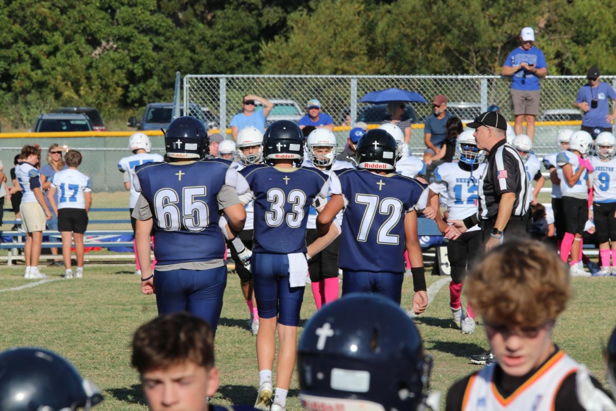 Captions walking to the coin toss