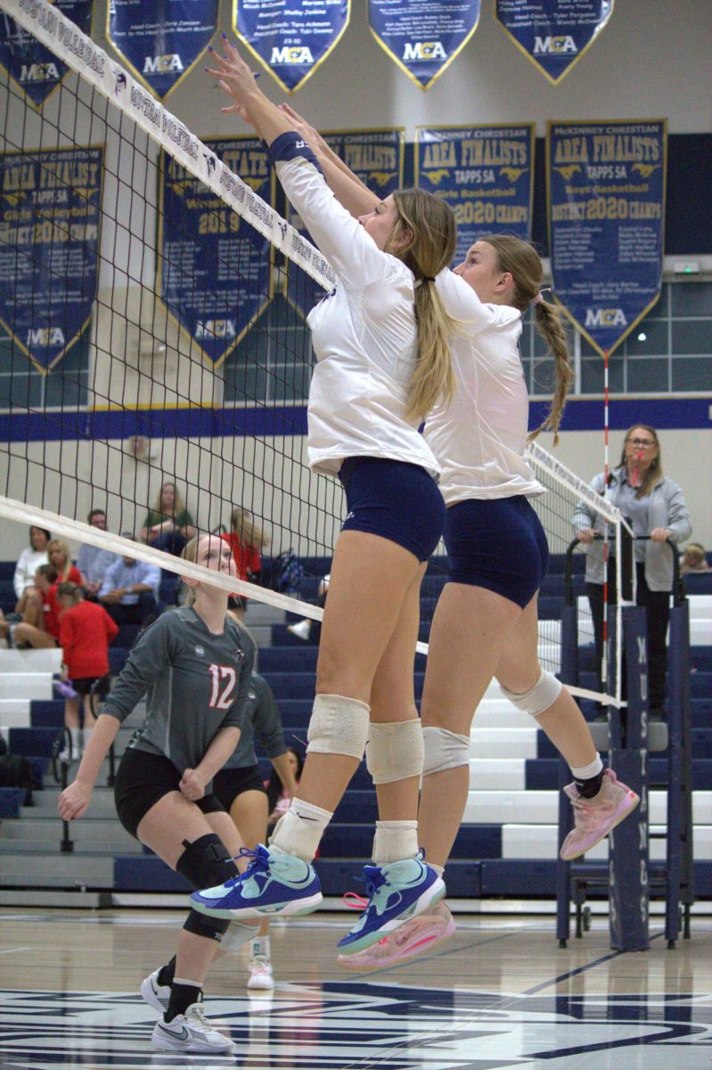 Sophomore, Brittany Bartoo, and senior, Sadie Blake, block the ball.