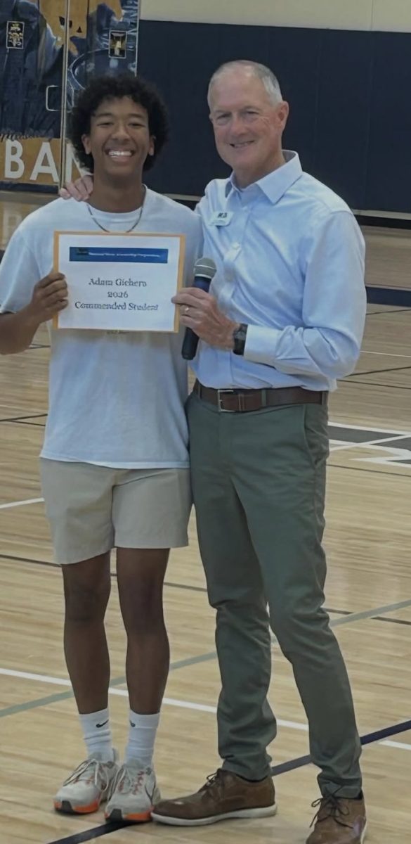 Adam receives award at community. 
