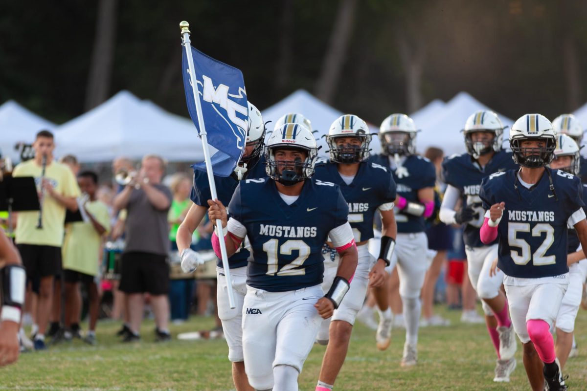 The Mustangs running onto the field