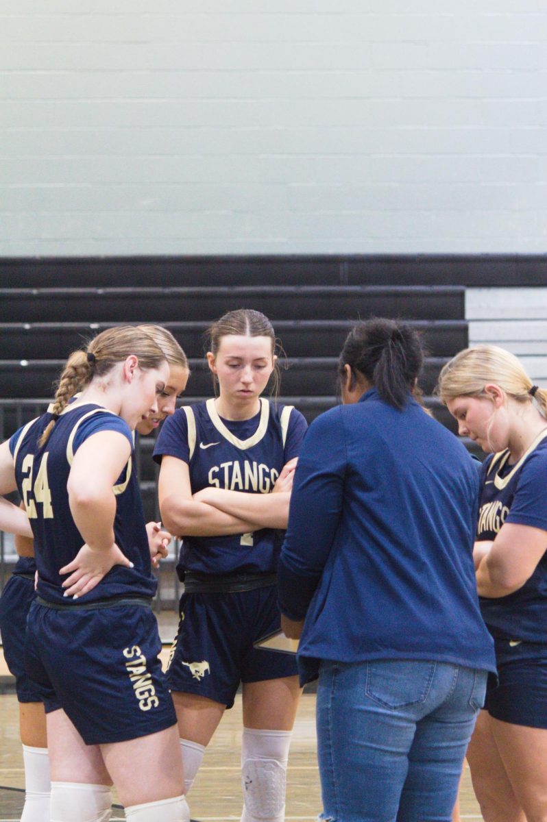 Team huddles up and talks about next play.