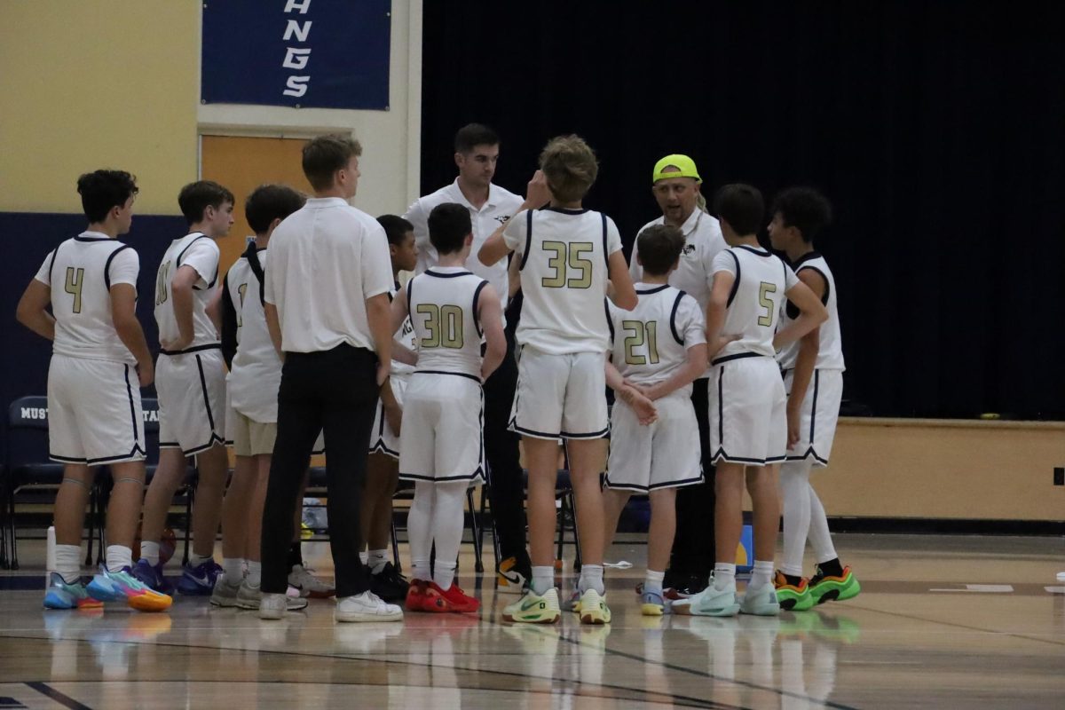 The Mustangs huddle during a time out.