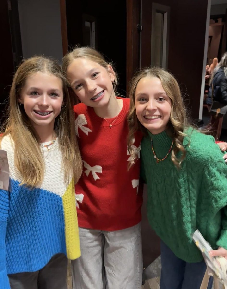 Girls pose together for a photo.