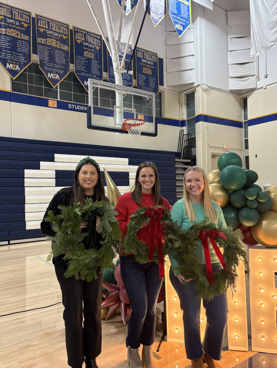 Ladies pose for a photo with their handcrafted wreaths. 