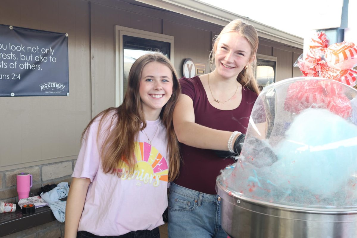 Senior girls make cotton candy.  