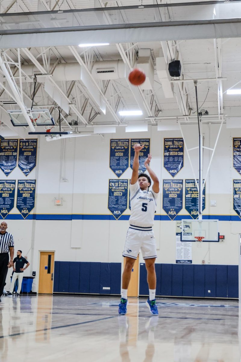 Junior, Evan Woodard taking his shot from the three point line
