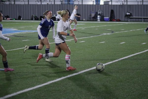 Senior, Tatum Barnard, brings the ball up the field.