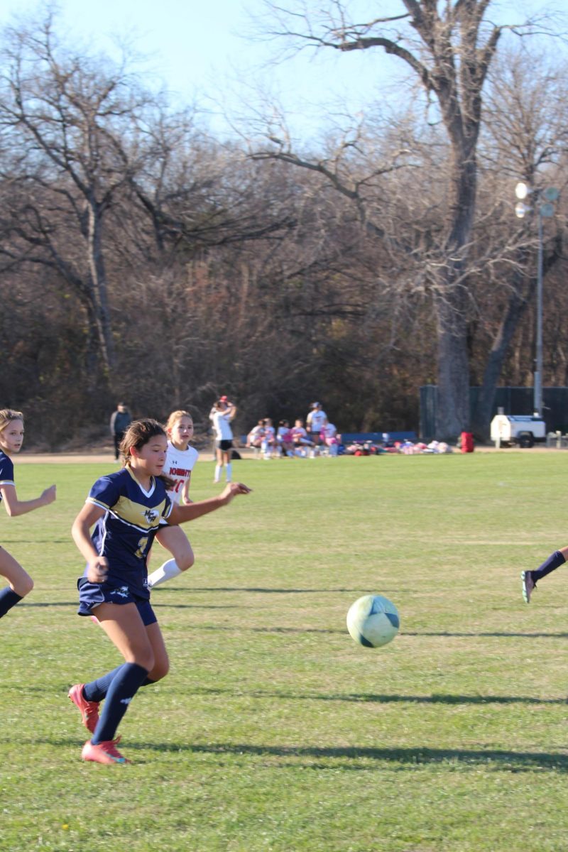 Seventh grader, Mikaela Hunt, dribbles down the field. 