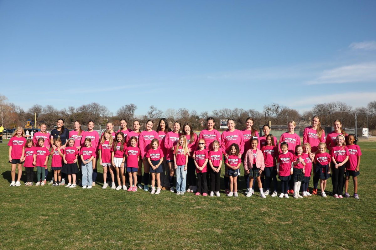 Varsity Girls soccer pose with their Little Stangs.