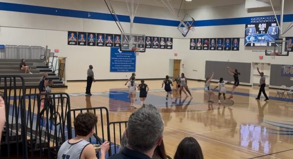 Sophomore, Elizabeth Thompson, shoots a three.