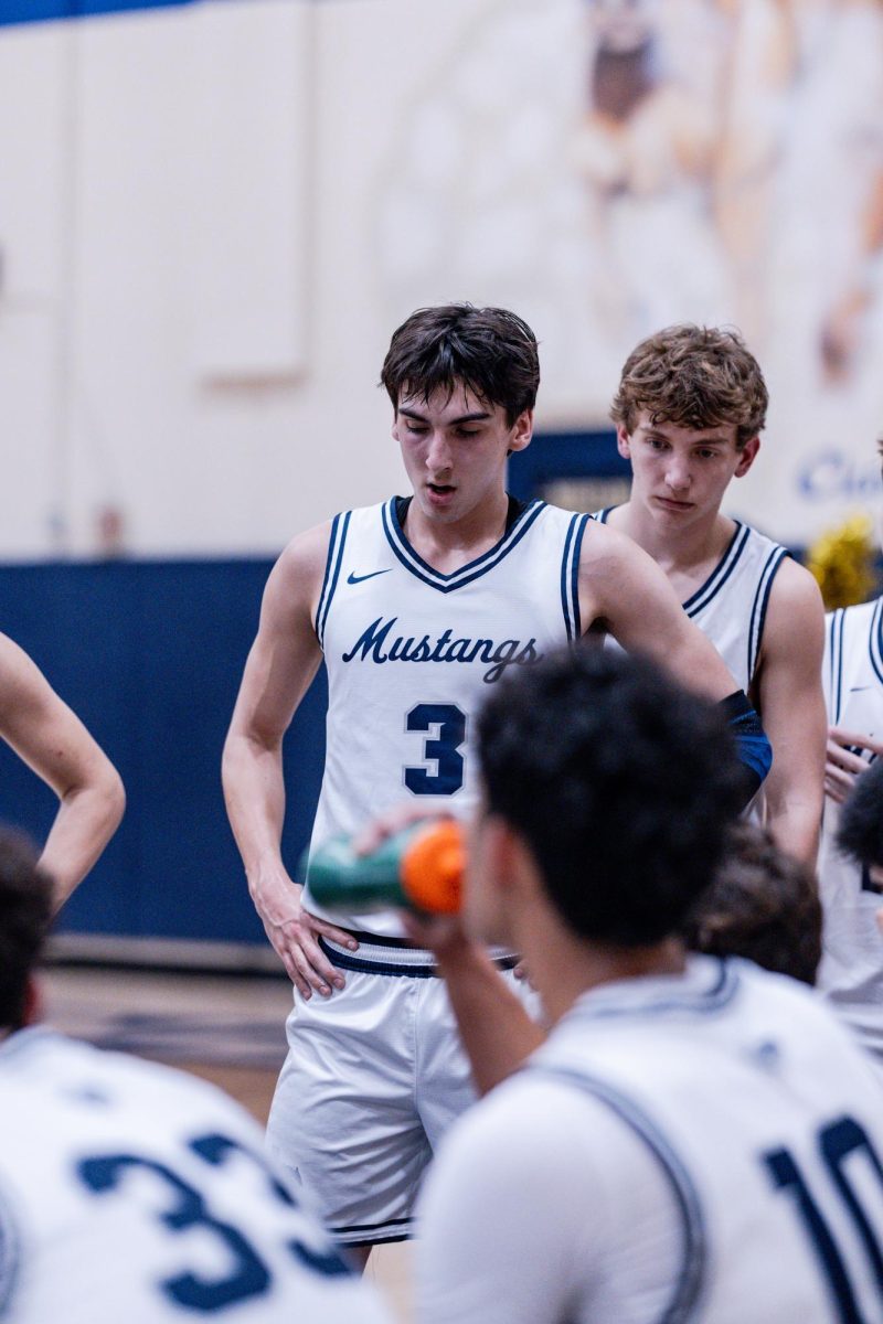 Senior, Manny Weaver, listens in on the huddle