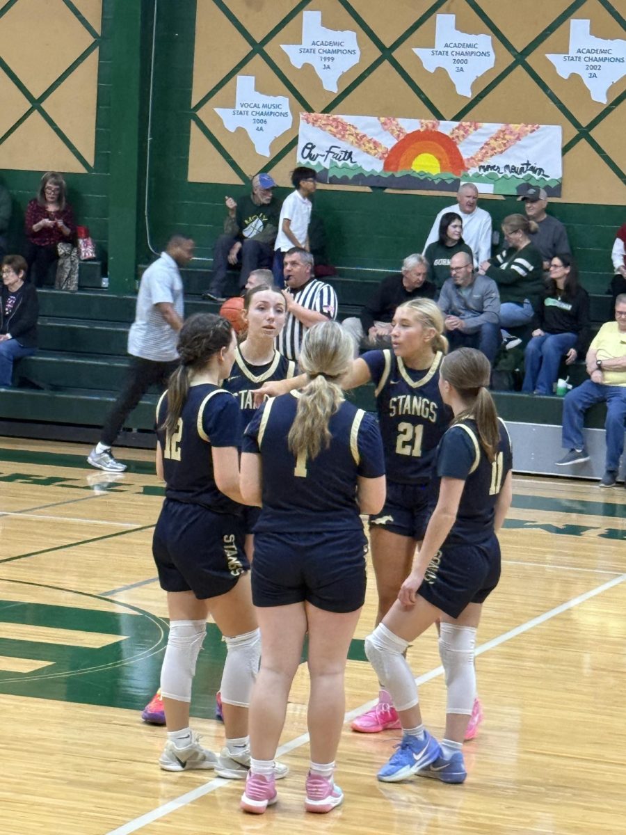 Lady Mustangs group together to discuss plays. 