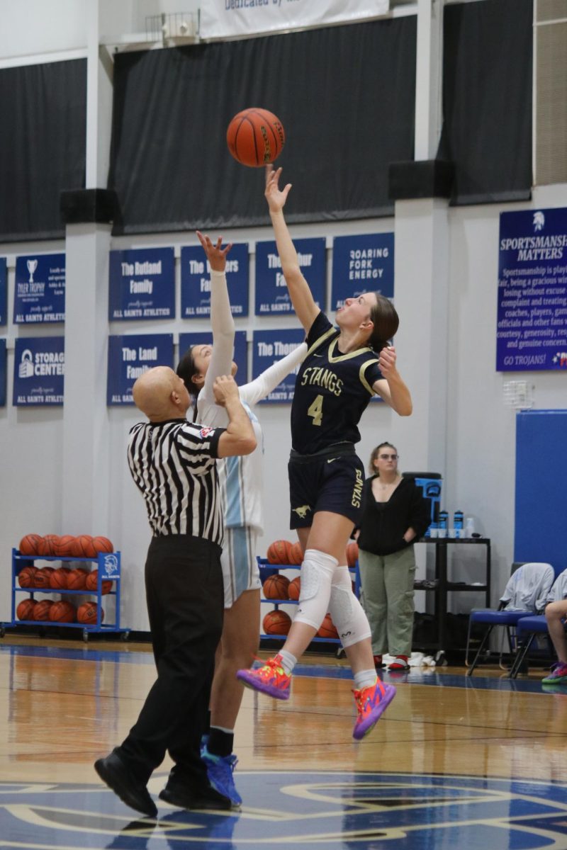 Sophomore, Elizabeth Thompson, jumps for tip off.