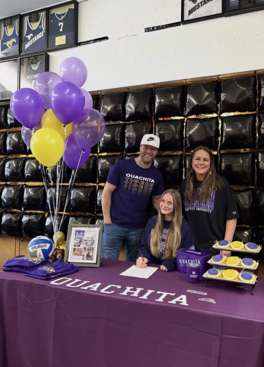 Senior, Sadie Blake, smiles for a photo with her parents.
