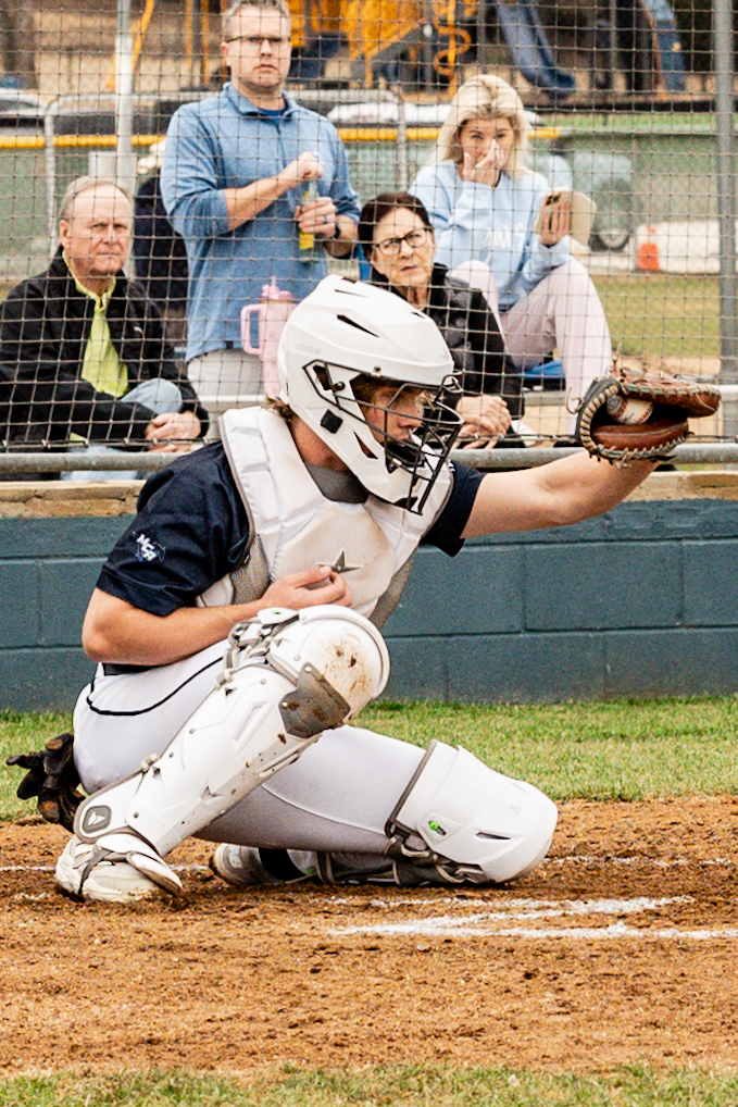 Senior, Porter Carrol, catches the pitch.