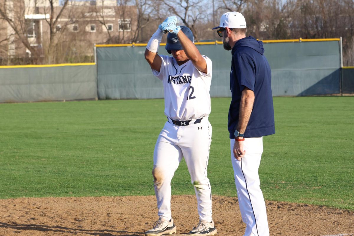 Junior, Angel Rivera, celebrates on first base.