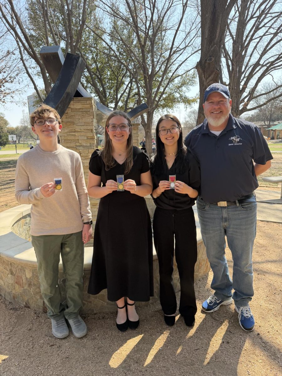 Band Students smile with awards.