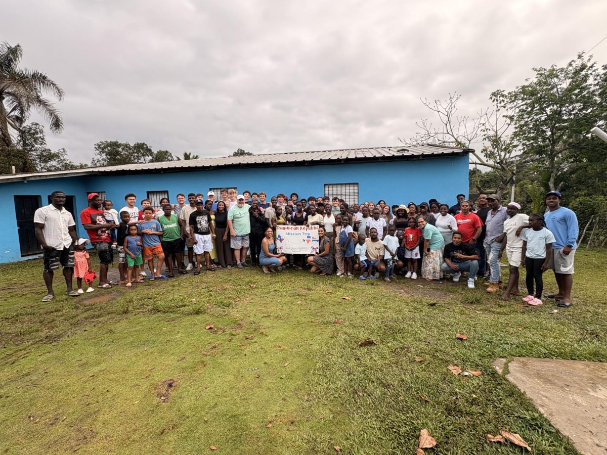 The Mustangs and the People from the DR take a picture together before the Mustangs leave from their mission trip.