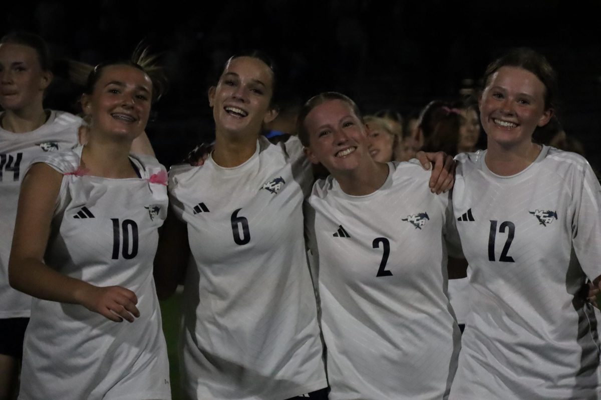 Freshman,Kate Thomas, Senior, Sadie Zbranek, Senior, Hannah Doshier, and Freshman, Sarah Webb, link arms to celebrate. 