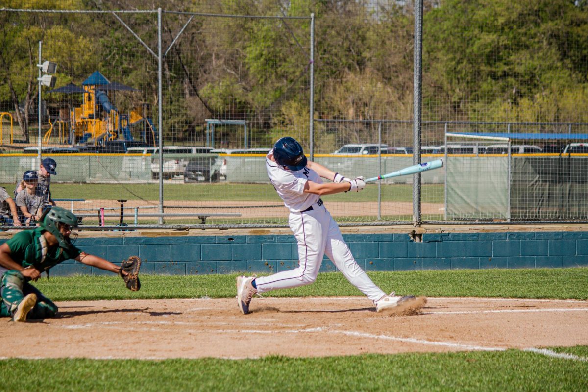 Junior, Ian Mulligan, hits the ball.