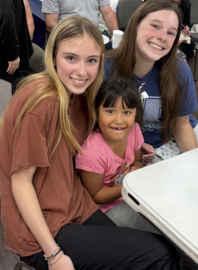 Freshman, Kennedy Whitehead and Claire McCarley serving Youth