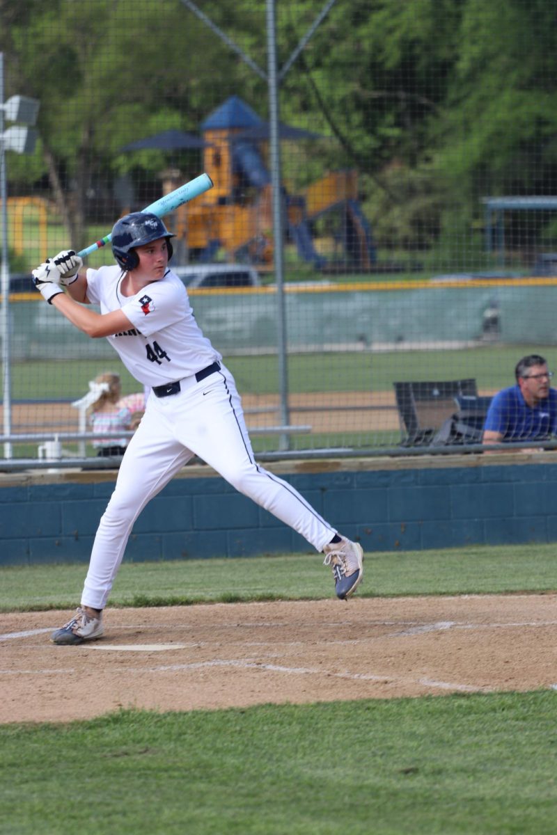 Junior, Ian Mulligan, swings the bat.