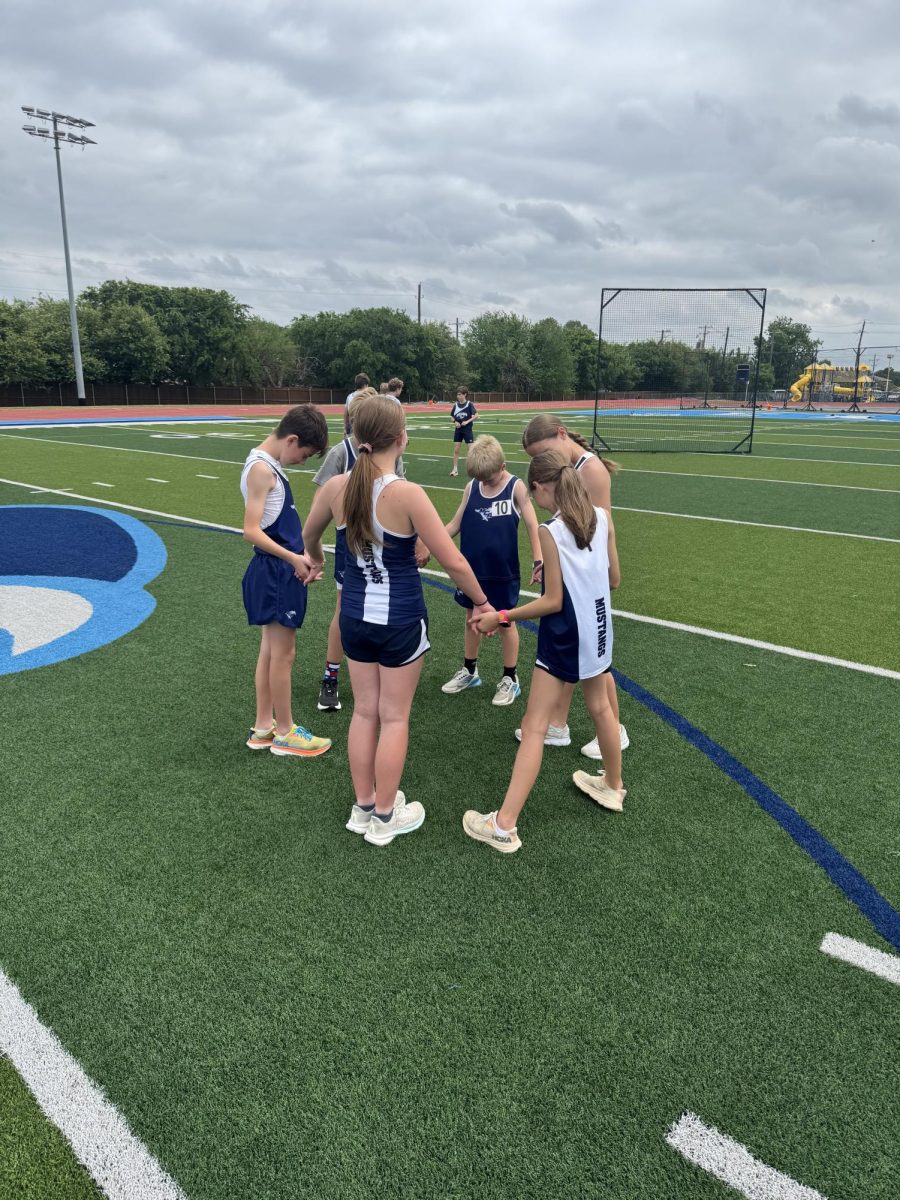 The team prays before the meet