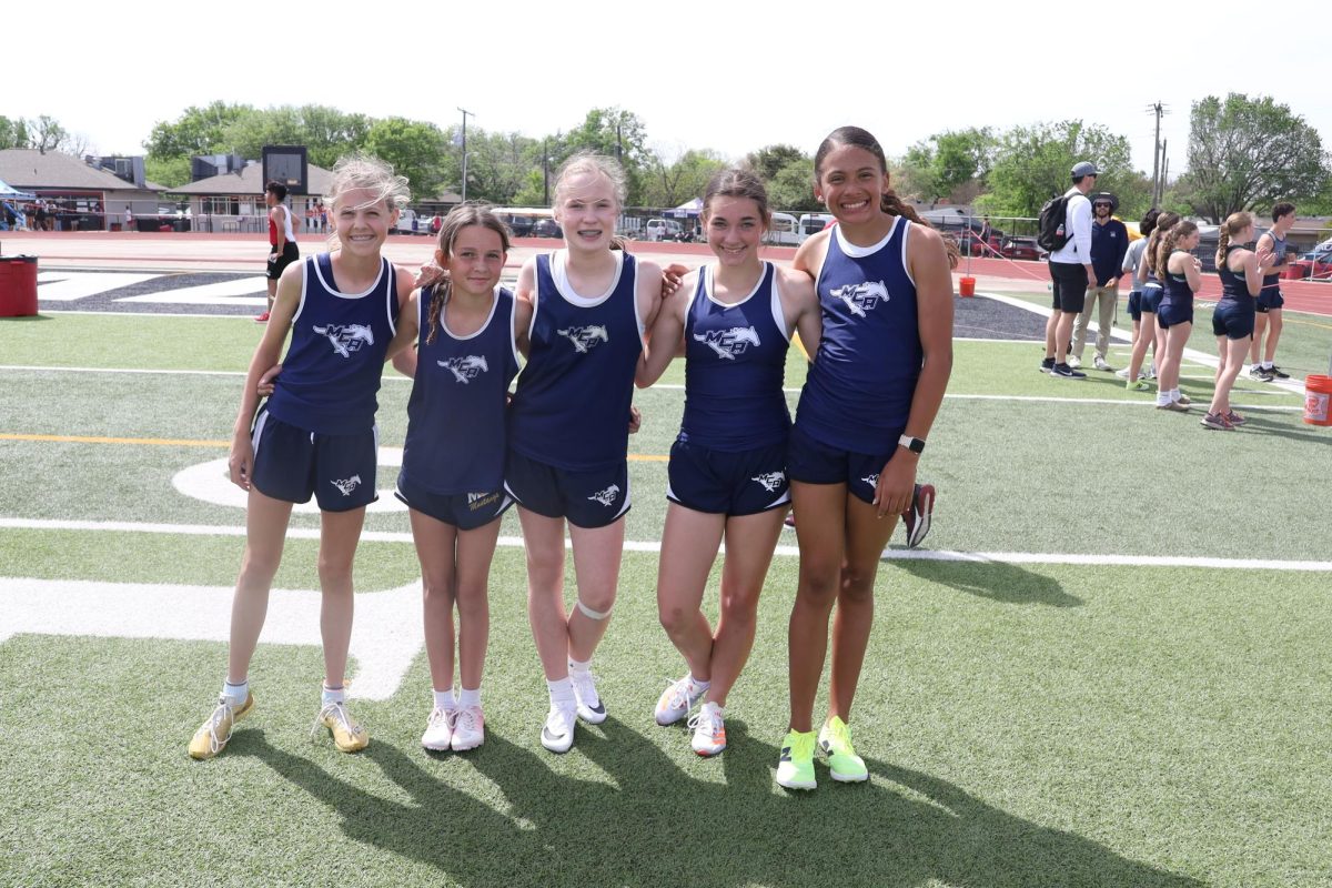 Girls take a group photo at the meet
